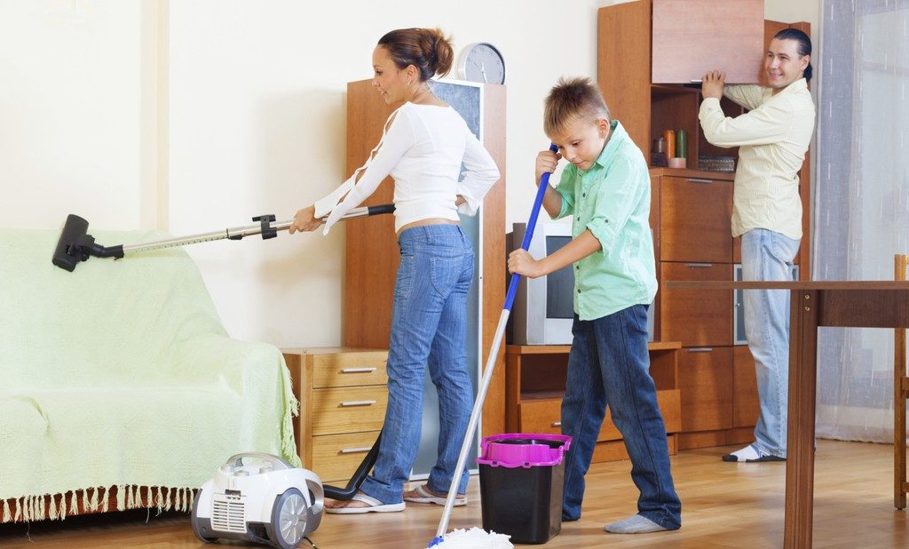 Ordinary family of three with teenager doing housework